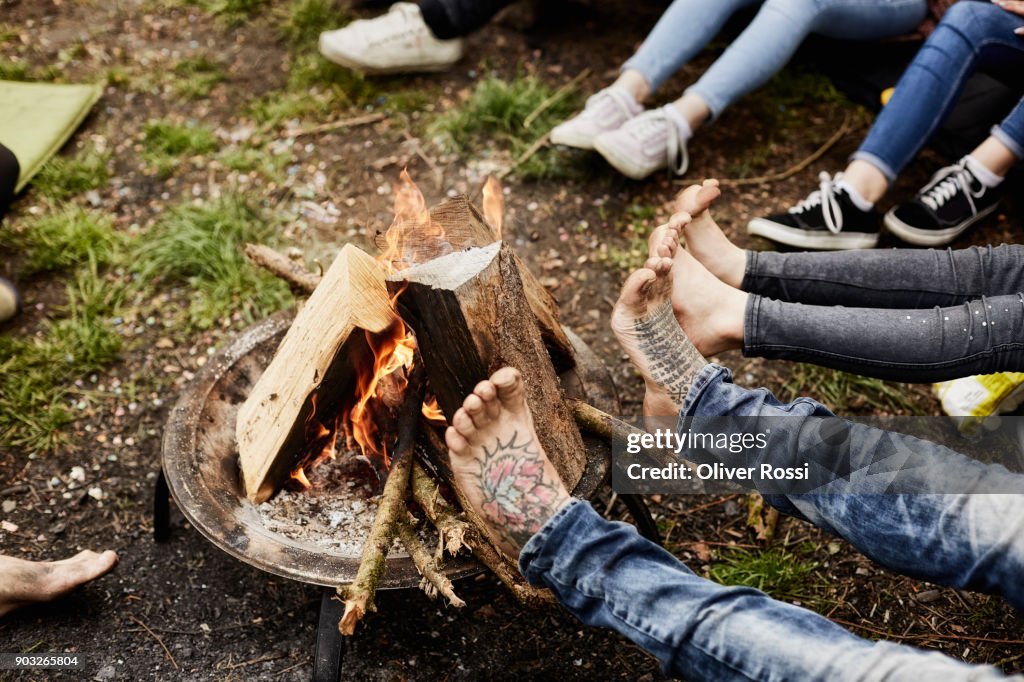 Legs around camp fire