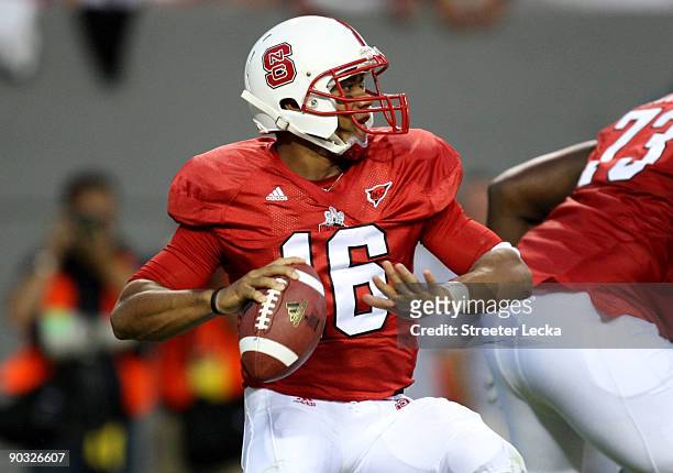 Quarterback Russell Wilson of the North Carolina State Wolfpack drops back to pass against the South Carolina Gamecocks during the game at...