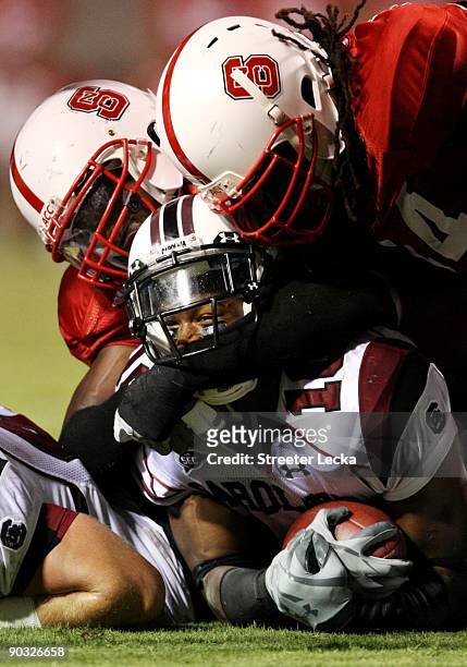 Running back Brian Maddox of the South Carolina Gamecocks is tackled during the game against the North Carolina State Wolfpack at Carter-Finley...