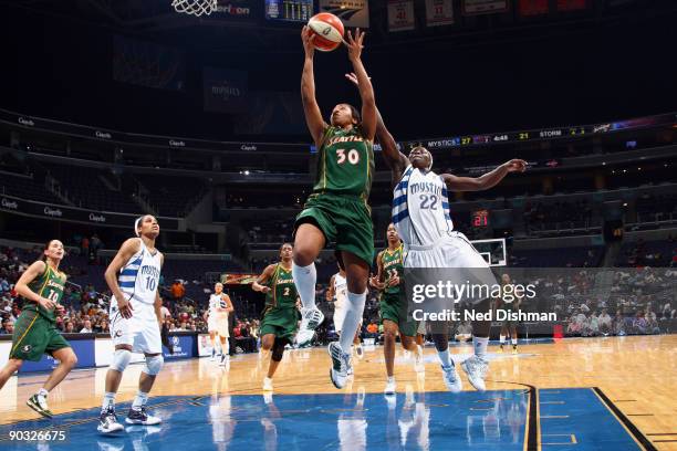 Tanisha Wright of the Seattle Storm shoots against Matee Ajavon of the Washington Mystics at the Verizon Center on September 3, 2009 in Washington,...