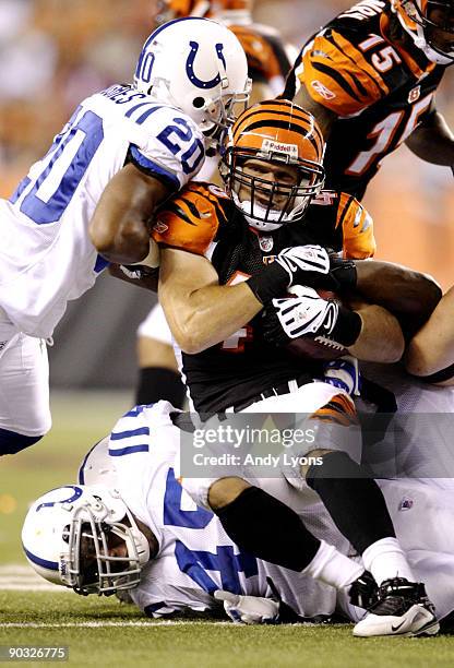 Foschi of the Cincinnati Bengals runs with the ball against Dante Hughes and Ramon Humber of the Indianapolis Colts during the preseason game on...