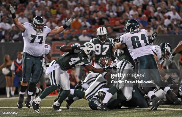 Guard Mike McGlynn of the Philadelphia Eagles signals the touchdown as quarterback Michael Vick lays at the bottom of the pile during the game...