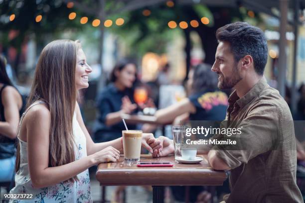 beautiful happy couple dating outdoors in a café - table for two stock pictures, royalty-free photos & images
