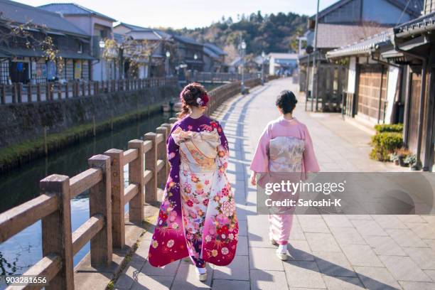 mother and daughter walking along river on coming of age day - seijin no hi stock pictures, royalty-free photos & images