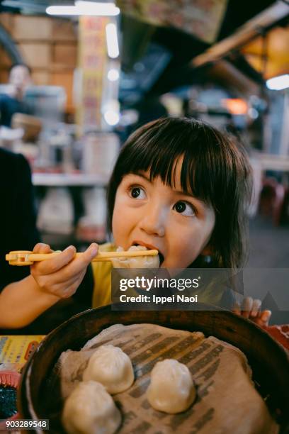 child eating xiaolongbao at night market, taiwan - asian food stock pictures, royalty-free photos & images