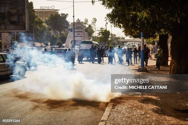 Malian police forces use tear gas to disperse a group of demonstrators marching towards the French Embassy in Bamako, to protest against the...