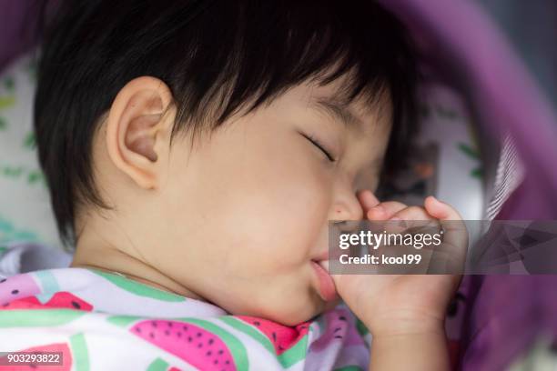 baby sleep to thumb sucking - thumb sucking stock pictures, royalty-free photos & images
