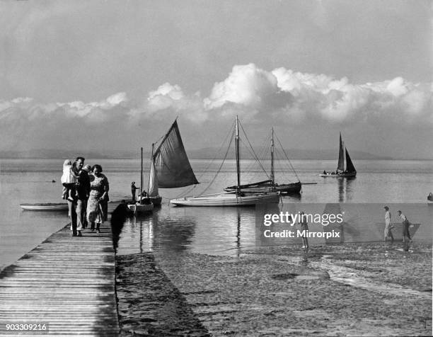 Holiday at Morecombe - Picture taken yesterday of holiday makers returning from a sail in the bay. The Lake District hills can be seen in the...