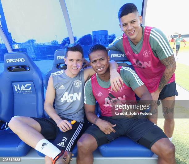Ander Herrera, Antonio Valencia and Marcos Rojo of Manchester United in action during a first team training session at Nad Al Sheba Sports Complex on...