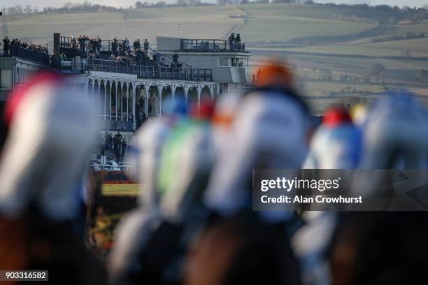 Racegoers watch from the grandstands as runners turn into the straight at Ludlow racecourse on January 10, 2018 in Ludlow, England.