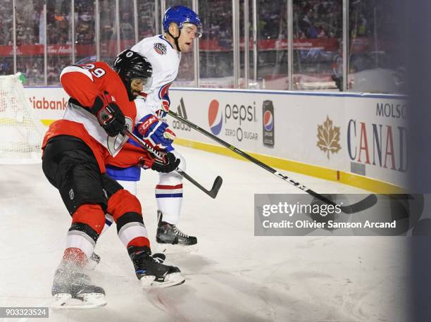 Johnny Oduya of the Ottawa Senators races for the puck with Byron Froese of the Montreal Canadiens during the 2017 Scotiabank NHL 100 Classic at...