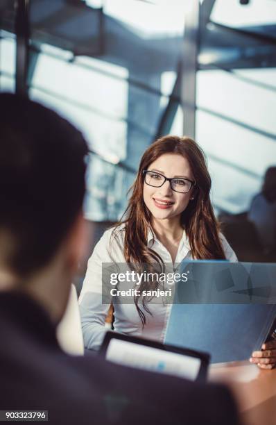 businesswoman talking to client or colleague - bank of slovenia stock pictures, royalty-free photos & images