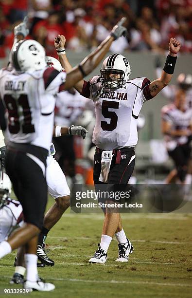 Stephen Garcia of the South Carolina Gamecocks celebrates after a 7-3 victory over the North Carolina State Wolfpack during their game at...