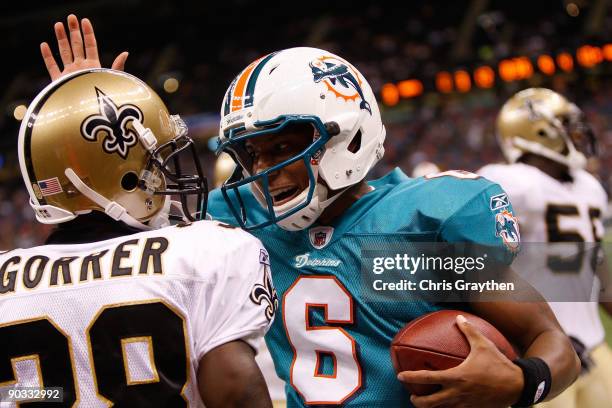 Quarterback Pat White of the Miami Dolphins talks with Danny Gorrer of the New Orleans Saints at the Louisiana Superdome on September 3, 2009 in New...