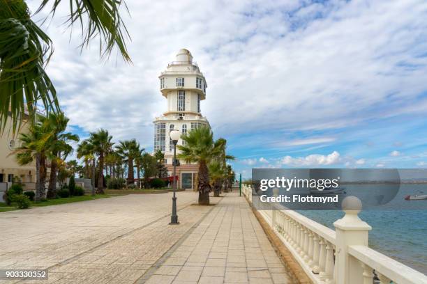 lighthouse of isla cristina as seen from the boulevard - costa de la luz stock-fotos und bilder