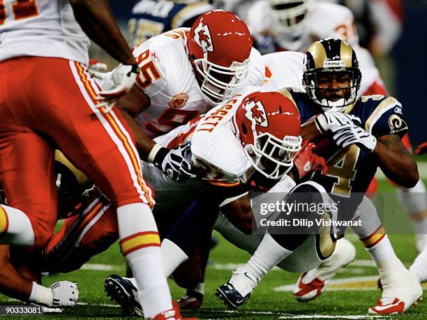 Running back Kenneth Darby of the St. Louis Rams is tackled by Maurice Leggett and Ron Edwards of the Kansas City Chiefs during the second quarter of...