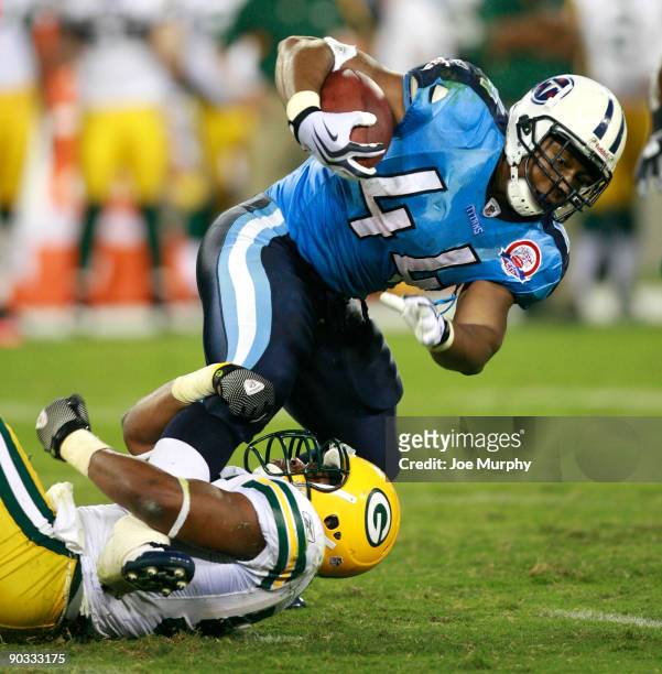 Rodney Ferguson of the Tennessee Titans is tackled by Desmond Bishop of the Green Bay Packers during a preseason NFL game at LP Field on September 3,...