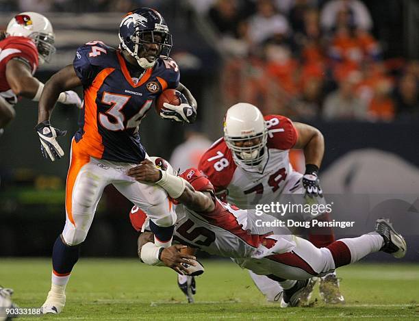 Running back Darius Walker of the Denver Broncos gains four yards tackled by line backer Ali Highsmith of the Arizona Cardinals during the NFL...