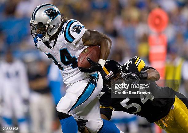 DeAngelo Williams of the Carolina Panthers is brought down by Andre Frazier of the Pittsburgh Steelers during their preseason game at Bank of America...