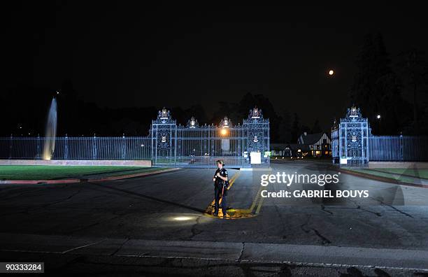 Police officer awaits the arrival of the Jackson family for the burial ceremony of US pop icon Michael Jackson at Glendale Forest Lawn Memorial Park...