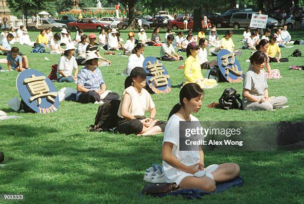 Followers of the popular quasi-religious meditation sect Falun Gong meditate outside the Capitol building in Washington, DC, Thursday, July 29, 1999....