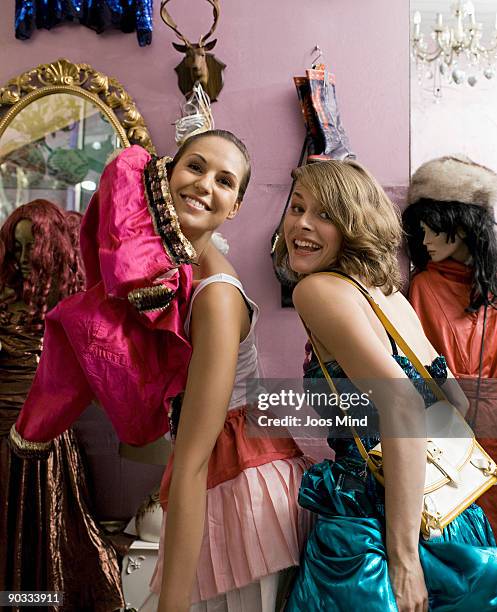 two girlfriends having fun in second-hand store - mannequin blonde stockfoto's en -beelden