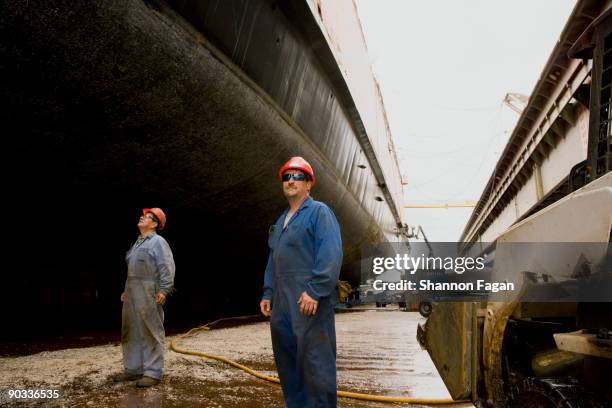 two men standing in shipyard - shipbuilder stock pictures, royalty-free photos & images