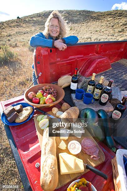 woman presenting fall tailgate picnic - wine bottle transport stock pictures, royalty-free photos & images