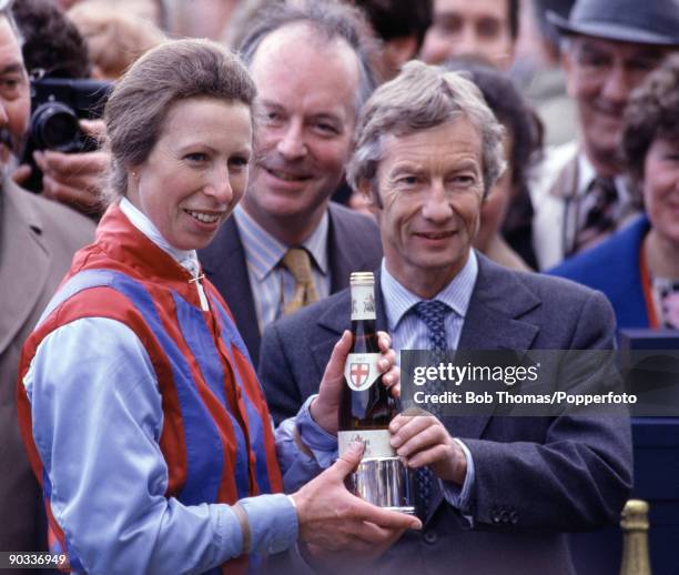 Princess Anne receives a commemorative trophy from Lester Piggott after making her flat racing debut at the Farriers Invitation Private Sweepstakes...