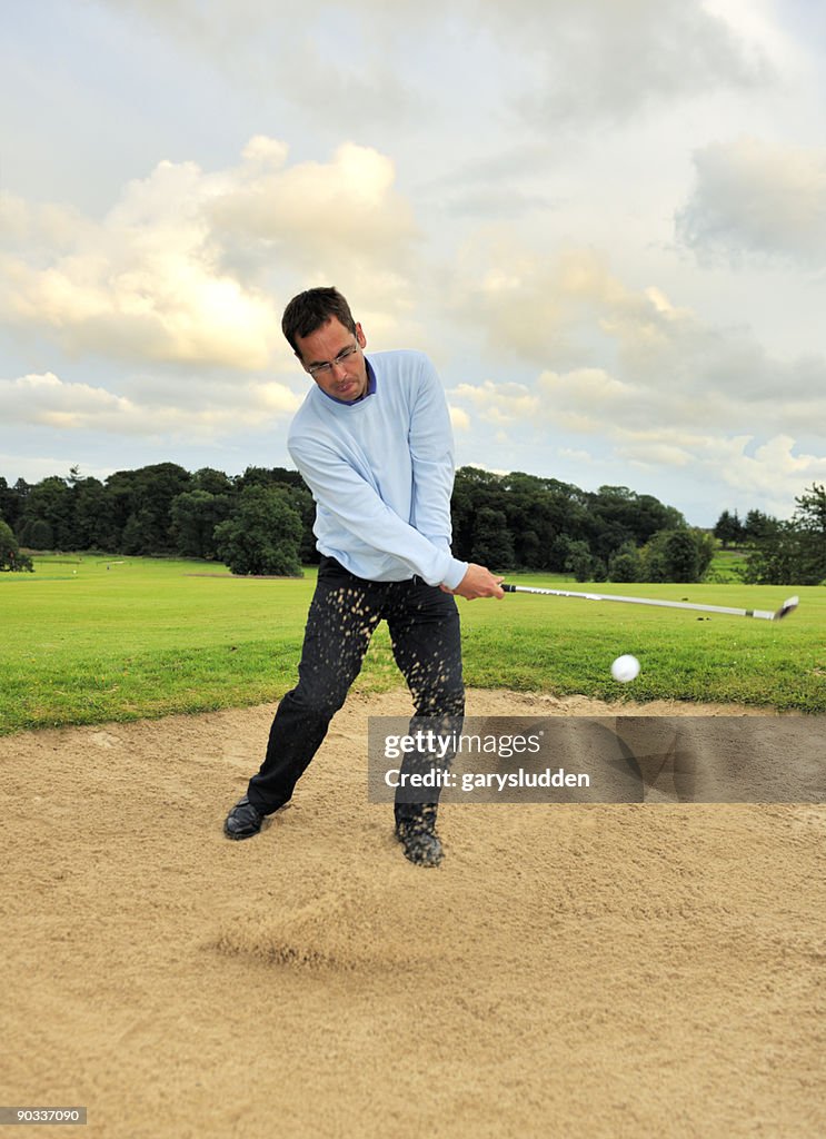 Man playing golf in evening