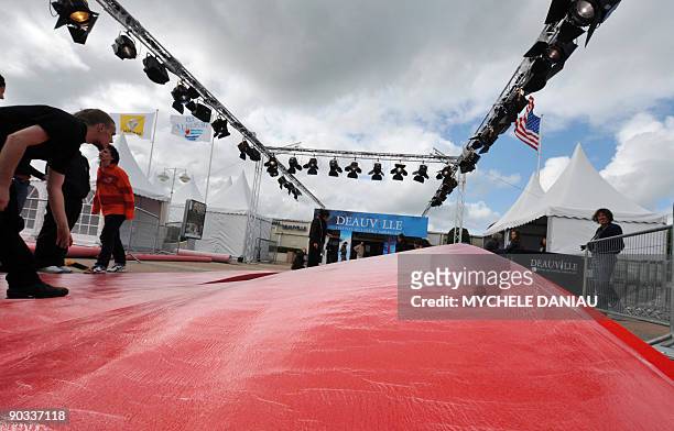People prepare a red carpet on September 4, 2009 in Deauville on the French northwestern coast, on the openning day of the 35th US film festival....