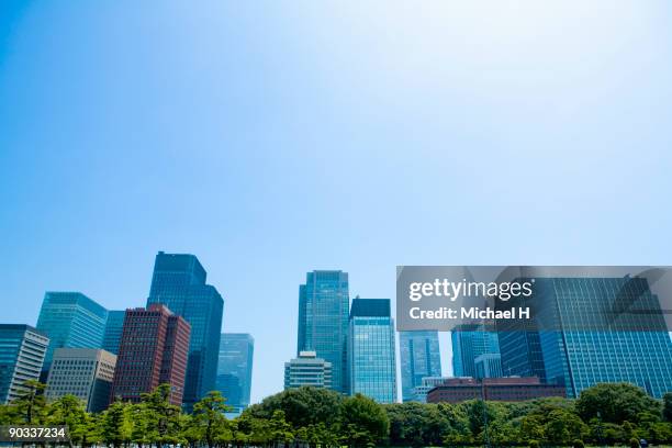 building and blue sky of marunouchi - low angle view ストックフォトと画像