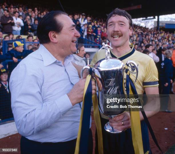 Chairman Robert Maxwell and captain Malcolm Shotton of Oxford United hold the Milk Cup trophy before the Oxford United v Arsenal Division 1 match...