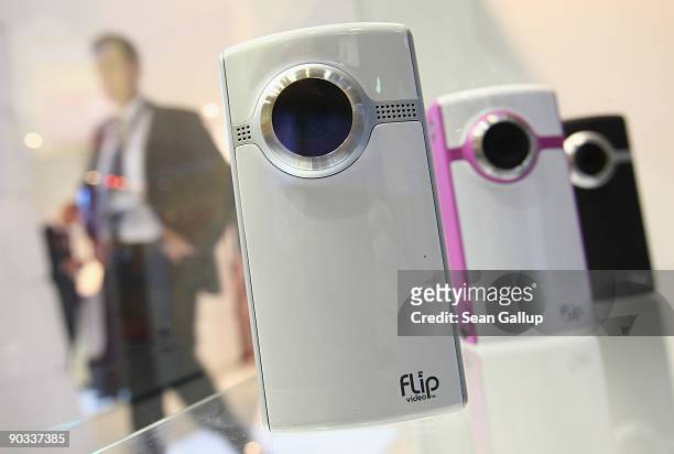 Visitors look at miniature camcorders at the Flip Video stand on opening day at the IFA technology trade fair on September 4, 2009 in Berlin,...