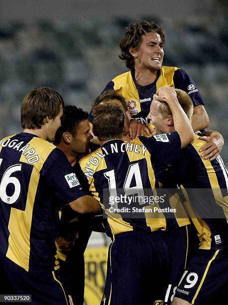 Mariners players celebrate after Alex Wilkinson scored a goal during the round five A-League match between the Central Coast Mariners ans the Perth...