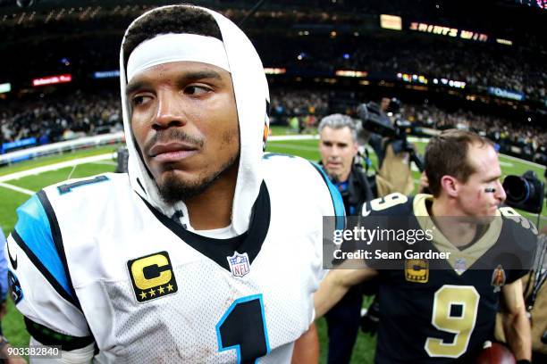 Cam Newton of the Carolina Panthers walks off the field after his team was defeated by the New Orleans Saints during the second half of the NFC Wild...
