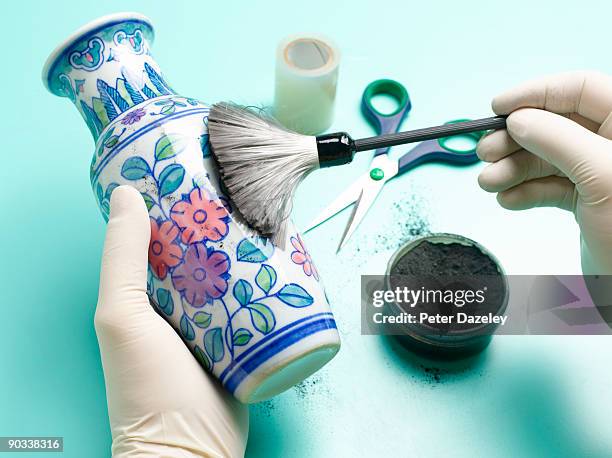 forensic scientist dusting vase for fingerprints. - man dusting stock pictures, royalty-free photos & images