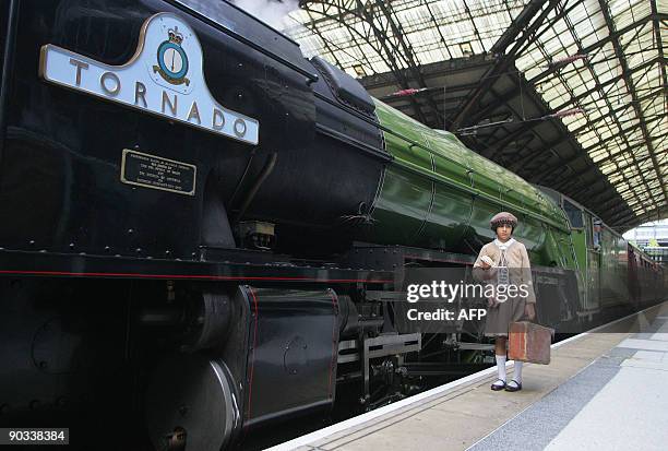 Young girl re-enacts the arrival of children evacuated from Nazi-occupied Czechoslovakia 70 years ago, at Liverpool Street Station, in London, on...