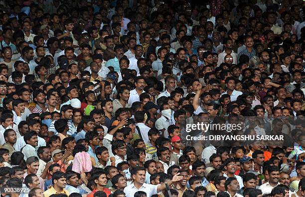 Supporters look on during a service for deceased Indian Chief Minister of Andhra Pradesh Y S Rajasekhara Reddy at the Lal Bahadur Shastri stadium in...