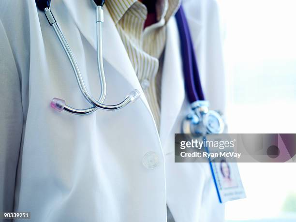 detail of a doctor's stethascope and name badge  - laborkittel stock-fotos und bilder