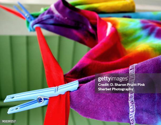 happy rainbow shirt pinned on clothesline - rainbow pin stock pictures, royalty-free photos & images