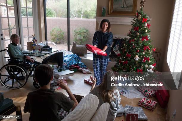 The Rosier family spends Christmas morning exchanging gifts on December 25, 2017 in Phoenix, Arizona.