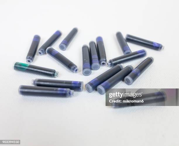 pen ink cartridge. close up of the nib of a fountain pen ink cartridges. inks as background. texture photo studio photography - cartridge stock pictures, royalty-free photos & images