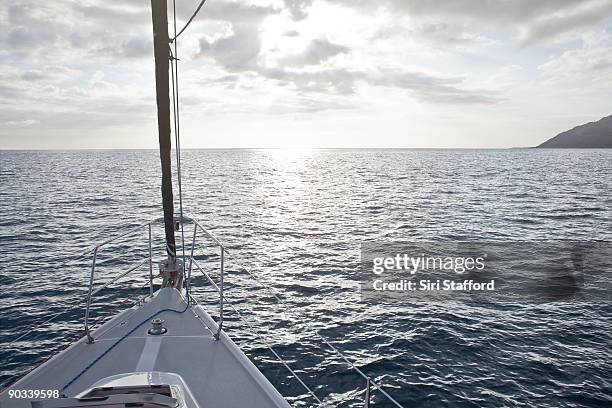 bow of sailboat pointing into sunset - siri stafford fotografías e imágenes de stock