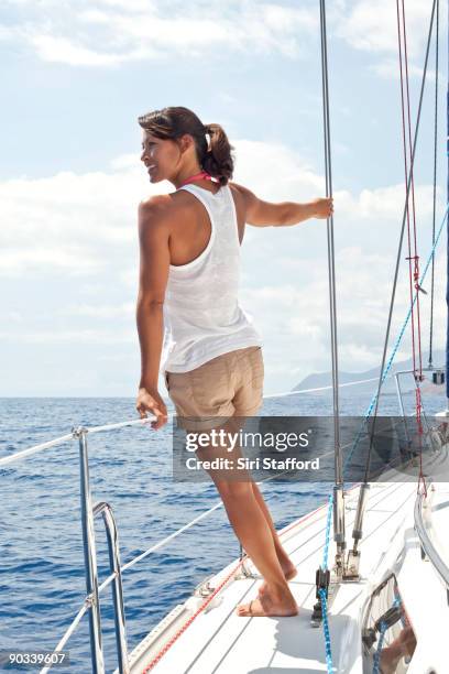 young woman on sailboat looking out - siri stafford stock pictures, royalty-free photos & images