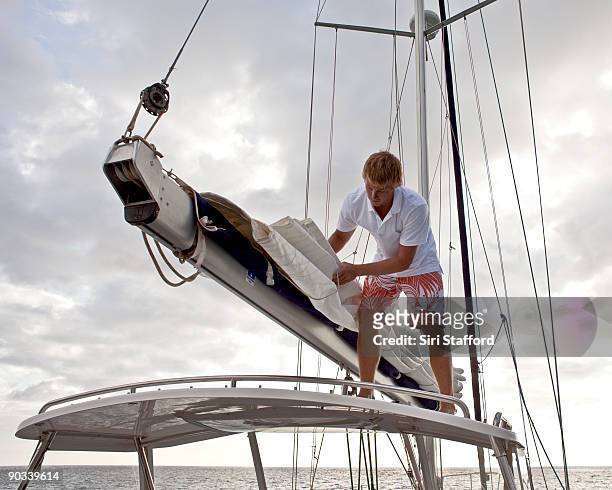 young man preparing sails - siri stafford fotografías e imágenes de stock