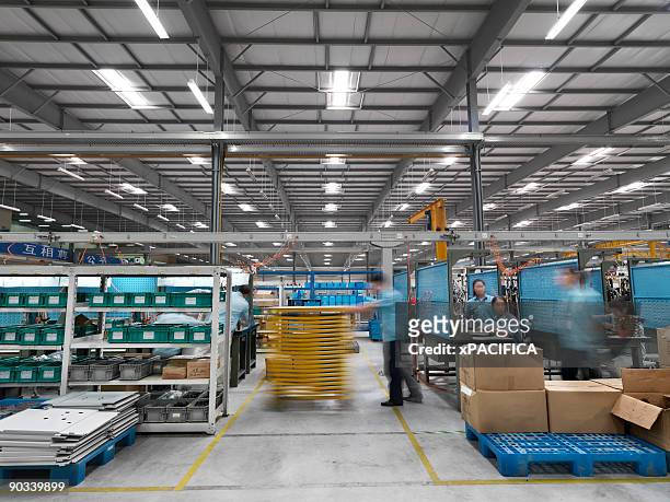workers on a high tech factory floor - factory foto e immagini stock