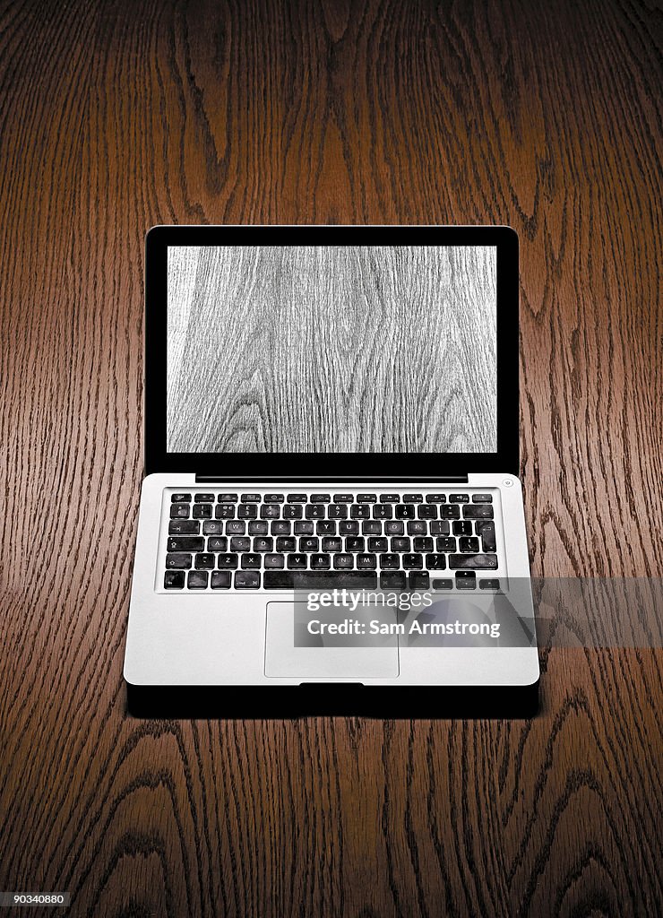 Laptop on a wooden background