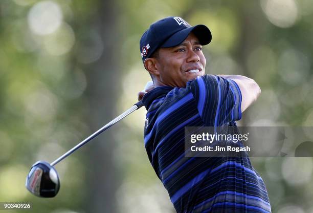 Tiger Woods works out of the rough during the first round of the Deutsche Bank Championship held at TPC Boston on September 4, 2009 in Norton,...