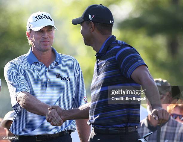 Tiger Woods shakes hands with Steve Stricker during the first round of the Deutsche Bank Championship held at TPC Boston on September 4, 2009 in...